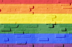 [ai] A brick wall painted with horizontal stripes in the colors of the rainbow: red, orange, yellow, green, blue, and purple.